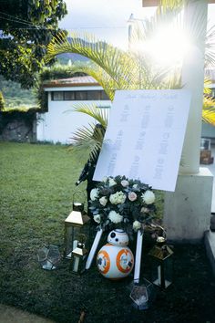 a star wars themed memorial with flowers and lights on the grass in front of a house