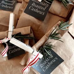 wrapped christmas presents with holiday ribbons and tags on them are sitting in brown paper bags