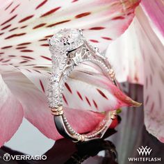 a close up view of a diamond ring on top of a flower with the words veragio written below it