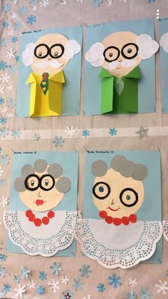 paper cut out of old people with glasses on them and snowflakes around them