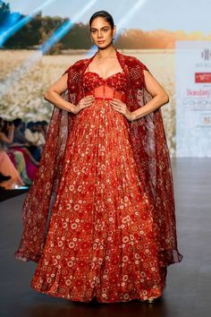 Red corset style gown with floral print and embroidery on the yoke. Paired with an asymmetric embroidered cape. - Aza Fashions Printed Corset, Cape Women, Cape For Women, Embroidered Cape, Corset Gown, Red Corset, Gown Pattern, Ladies Gown, Corset Style