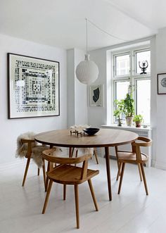 a dining room table with four chairs around it