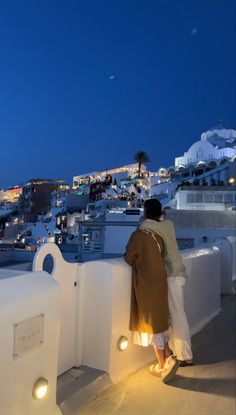 Couple romance looking at view in Santorini Greece Couples Traveling Photos, Couple Trips Aesthetic, Greece Aesthetics Honeymoon, Couples In Santorini, Vision Board Couples Ideas, Summer Vacation Couple, Santorini Photo Ideas Couple