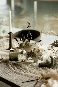 a table topped with lots of flowers and candles