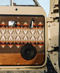 an old car door with a pattern on the front and side panel, showing the interior