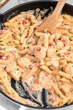 a skillet filled with pasta and meat covered in sauce