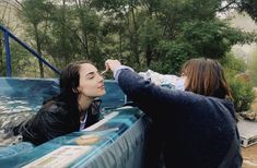 two women are in an outdoor hot tub