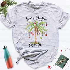 Custom Christmas Palm Tree Family Shirt, Family Christmas Tropical Shirts, Hawaiian Christmas Palm Tree Shirts, 2024 Christmas Family Shirt. Hi! Welcome to our store. It's good to see you here. Our aim is to offer you first-class clothing in your most beautiful moments with our graphic t-shirts that we designed or designed with your ideas. I am sure you will like our designs for your family, friends and you. IMPORTANT MATTERS FOR ORDERING: 1-) Please check and review all photos. 2-) Our sizes ar Christmas Tropical, Tree Shirts, Christmas Palm Tree, Christmas Family Shirt, Hawaiian Christmas, Tree Family, Class Outfit, Christmas T Shirt Design, Tropical Christmas