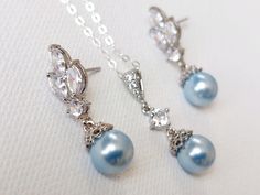 This is a RESERVED listing for Special Customer! Wedding Light Blue Blush Blue Pearl Cubic Zirconia Silver Dainty Bridal Earrings and Necklace Jewelry Set with .925 Sterling Silver Chain. EARRINGS are 1.06 inch (2.7cm) long from top of erring stud to bottom. CHAIN is 24 inches long. PENDANT is about 1.06 inch (2.7cm) including bail. Elegant and timeless, these dainty jewelry set is perfect for weddings or special occasions such as birthdays, anniversaries, graduations, proms...or whatever you ca Blue Wedding Jewelry With Matching Earrings, Elegant Blue Dangle Jewelry Sets, Blue Round Jewelry Sets For Wedding, Light Blue Teardrop Jewelry For Wedding, Elegant Light Blue Jewelry For Party, Elegant Light Blue Jewelry For Wedding, Blue Pearl Jewelry, Pearl Silver Jewelry, Wedding Light Blue