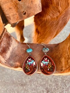 Add some wild west flair to your outfit with these Leather Stamped Aztec Horse Earrings! Choose from turquoise or pink stone and let these 2 1/2" dangle earrings make a statement. With a playful western style and easy fish hook closure, you'll be ready to ride off into the sunset. Giddy up! Aztec Horse, Horse Earrings, Leather Stamps, Sterling Jewelry, Wedge Heel Sandals, Pink Turquoise, Glitz And Glam, Pink Stone, Plus Dresses