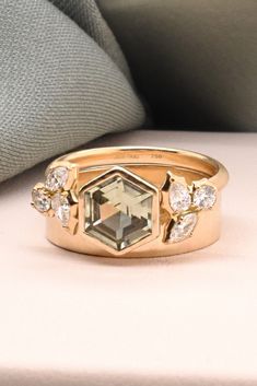 a gold ring with an octagonal cut diamond surrounded by smaller diamonds