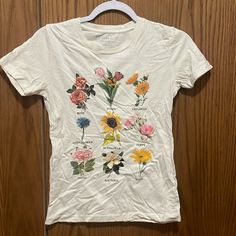 a white t - shirt with flowers on it