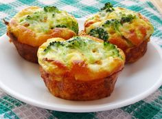 broccoli and cheese muffins on a white plate with a green checkered tablecloth