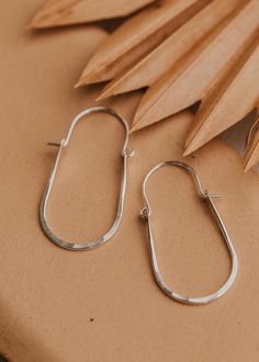 These hoops have just the right amount of movement thanks to the perfect amount of hammered texture and the swing latch design. Measures 2" long by 1" wide. Hoop hinge is made of 18g wire. Sold as a pair. Available in 14kt Gold Fill + Sterling Silver. Paired with our best-selling earring, the Tiny Twist Earrings. Handmade in Eau Claire, WI. Our jewelry is handmade so each piece will be unique and may vary slightly from what is pictured.