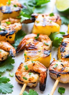 grilled shrimp and pineapple skewers with cilantro garnish