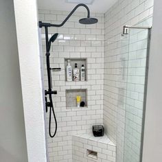 a bathroom with a shower, toilet and sink in it's stall door area