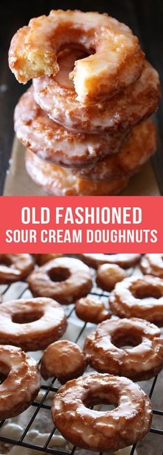 there are several different types of doughnuts on the cooling rack and in front of them is a pink sign that says old fashioned sour cream doughnuts