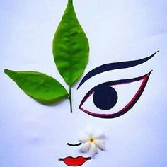 the face of a woman with green leaves on her forehead and red lips painted on it