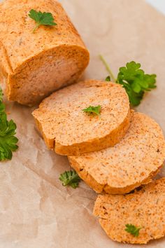 sliced bread and parsley on top of brown paper