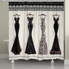 three dresses on display in front of a white shower curtain with black and white designs