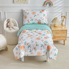 a child's bedroom with white walls and oranges on the bed coverlet