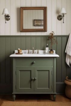 a bathroom with green painted walls and a white sink