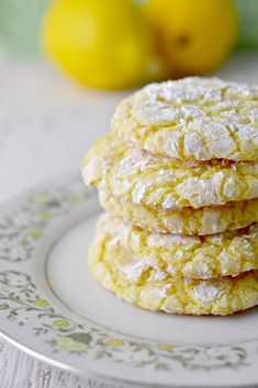 a stack of lemon cookies sitting on top of a white plate