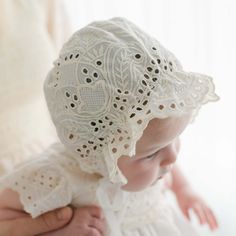 Handmade in the USA The Ingrid Lace Bonnet is a beautiful compliment to our Ingrid Christening Gown! Crafted with a 100% cotton lace in light ivory and a natural champagne tone. This lovely material has a vintage look we love! The back of the bonnet buttons for a unique detail. Designed to create sweet lace ruffles that frame her face. Light ivory cotton ribbons ties complete the design. 100% cotton 100% cotton ribbon ties Button back Beige Scalloped Lace For Spring, Cream Fitted Delicate Lace, Fitted Delicate Cream Lace, Delicate Fitted Cream Lace, Cream Crochet Lace For Spring, Spring Cream Crochet Lace, Fitted Cream Lace For Ceremony, Cream Fitted Lace For Ceremonies, Crochet Lace For Summer Weddings