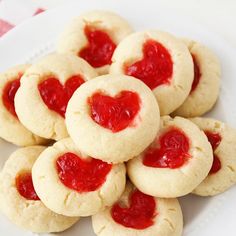 heart shaped cookies on a white plate with ketchup in the shape of a heart