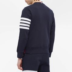 This navy blue sweater from.Thom Browne.is equal parts elegant and sporty. It teams premium cotton jersey with ribbed trims for all-day comfort, while the American designer’s iconic four-bar branding on the left sleeve and tricolour taping in the side seam complete the look..100% Cotton.Woven Brand Patch.Ribbed Trims.Made in Japan.Model is 6ft/1.82m with a 35.5”/90.2cm chest and wears a size 2. Bar Branding, Japan Model, Navy Blue Sweater, Sweat Top, Blue Sweater, American Design, Thom Browne, Blue Sweaters, Tri Color