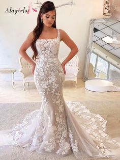 a woman in a white wedding dress posing for the camera with her hands on her hips