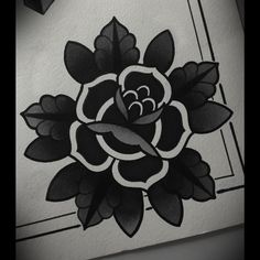 a black and white drawing of a rose on the wall in a room with a clock