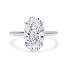 an oval cut diamond ring on a white background