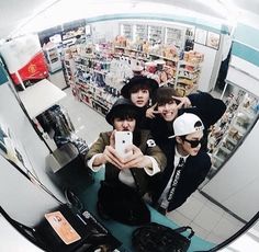 a group of young men taking a selfie in a store