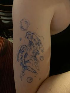 a woman with a tattoo on her arm