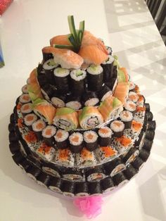 there is a large cake with sushi on it