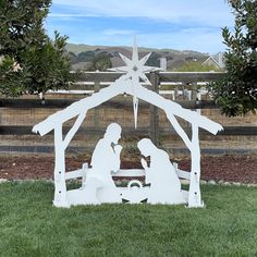 a nativity scene in the middle of a yard