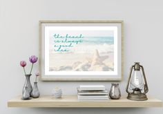 the beach is always nice to see framed art print on a shelf next to vases with flowers