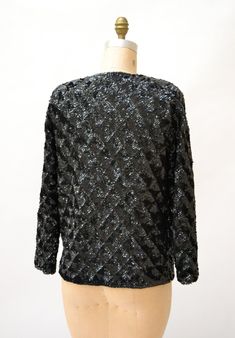 "Amazing Vintage Sequin Jacket Features: * fully embellished with black onyx sequins on wool body with woven lining * Basic neckline with long sleeves * Relaxed fit * great statement piece * Black lining and front hook and eye closure No Brand Sweater knit wool with synthetic lining Size 40, Fits like a Medium Era most likely the 50/60s In great condition, Beautiful jacket! Bust 40\" Bottom opening 39\" Body length from Shoulder seam 24\" Sleeve length from neck seam 27\" (can be taken out 1\") Glamorous Evening Cardigan For Winter, Glamorous Evening Winter Cardigan, Elegant Winter Cardigan With Sequins, Embellished Long Sleeve Cardigan For Party, Long Sleeve Sequined Evening Cardigan, Black Embellished Evening Outerwear, Black Embellished Winter Cardigan, Embellished Black Cardigan For Winter, Black Embellished Cardigan For Winter