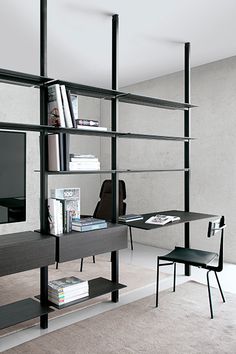 a room with a desk, chair and bookshelf