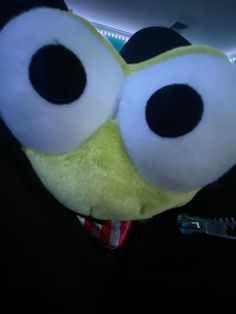 a close up of a stuffed animal with big eyes