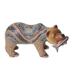 a bear figurine with a fish in its mouth