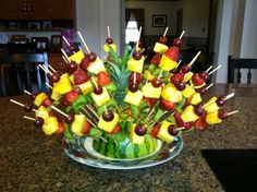 a glass bowl filled with fruit and veggies on top of a kitchen counter