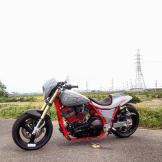 a red and silver motorcycle parked on the street