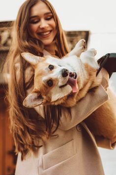 a woman holding a dog in her arms