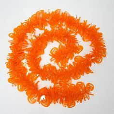 an orange string of plastic beads on a white surface with space for the bead to be sewn