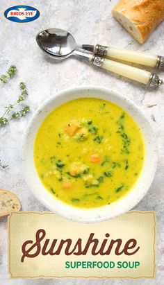 a white bowl filled with soup next to two slices of bread on top of a table