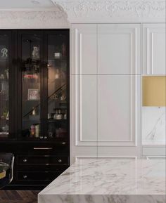 a kitchen with marble counter tops and white cabinets