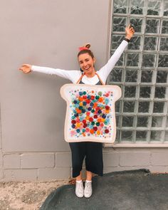 a woman holding up a large bag with gummy bears on it