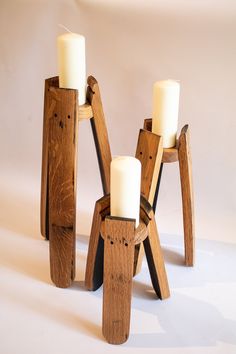 three wooden candles are placed on top of each other